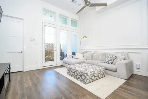 a living room with furniture and a floor to ceiling window