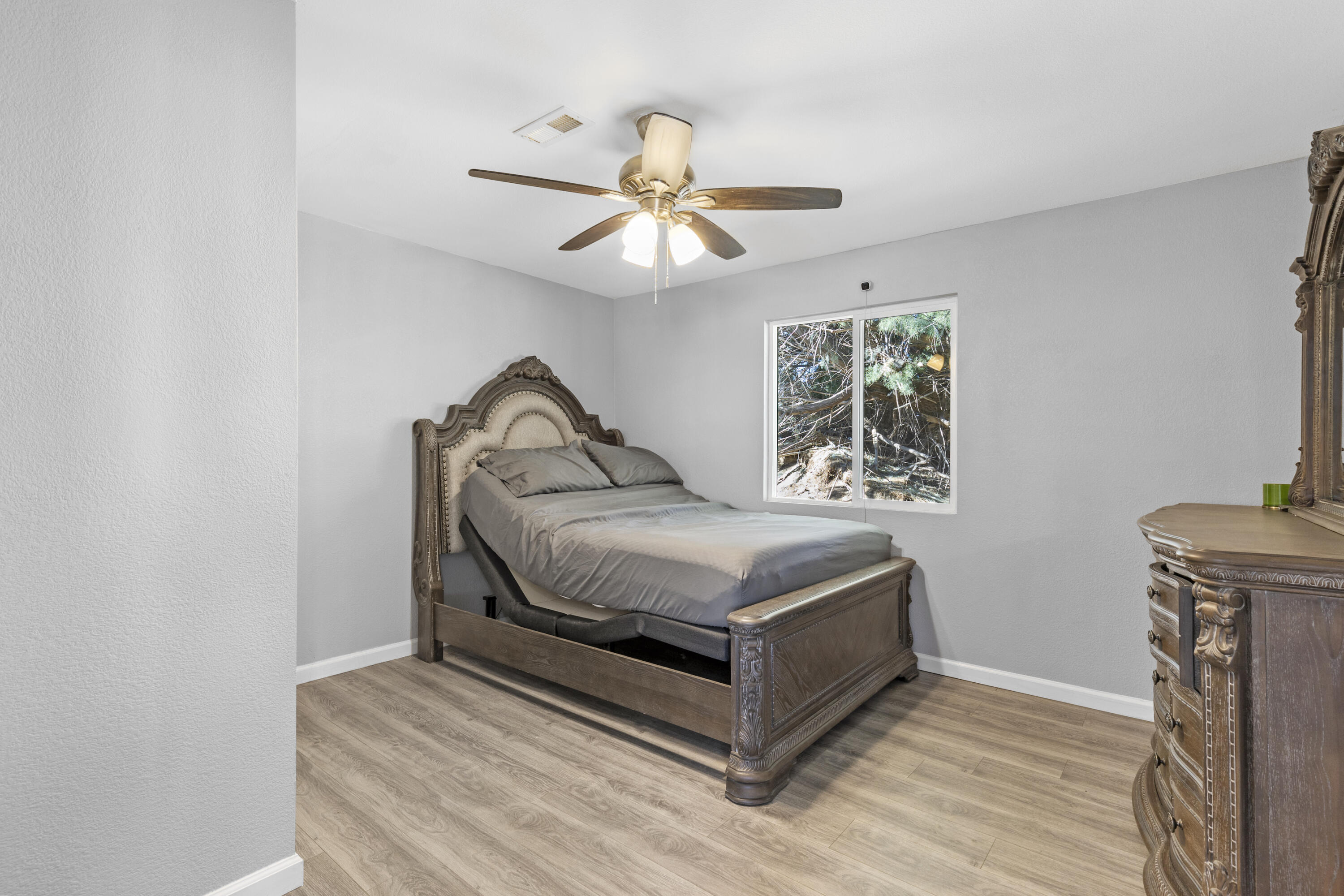 7512 Chapinite Road Mojave, CA 93501 - Photo 8 of 15 a bedroom with a bed and a chandelier