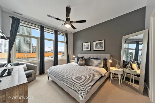 a bedroom with a large bed and a large window