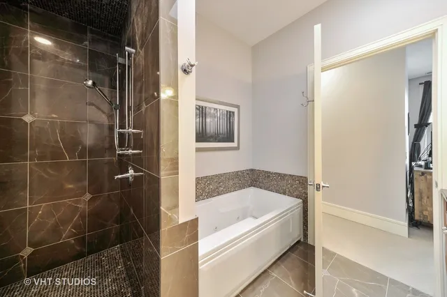 a bathroom with a bathtub and a shower
