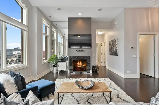 a living room with furniture a fireplace and a flat screen tv