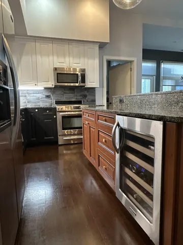 a kitchen with stainless steel appliances granite countertop a stove and a sink