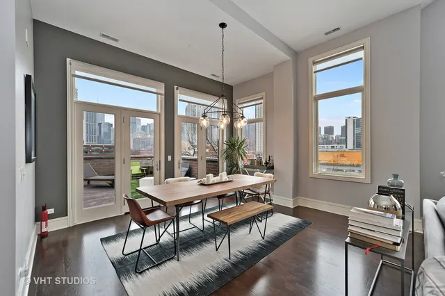 a dining room with furniture a chandelier and wooden floor