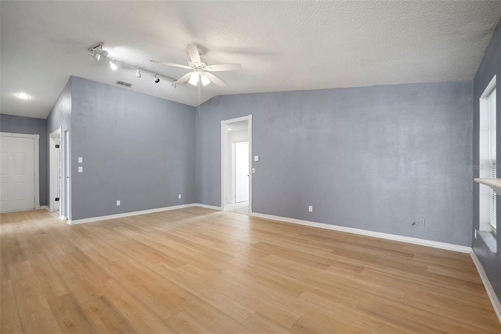 12825 Tallowood Drive Riverview, FL 33579 - Photo 16 of 43 a view of an empty room with wooden floor