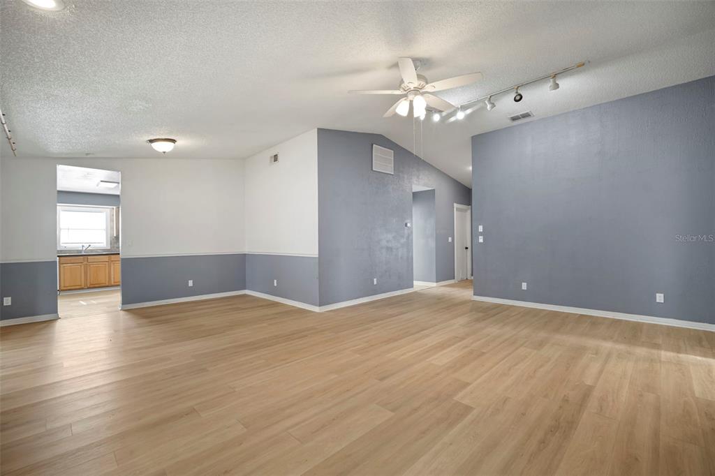 12825 Tallowood Drive Riverview, FL 33579 - Photo 17 of 43 a view of an empty room with glass door and chandelier fan