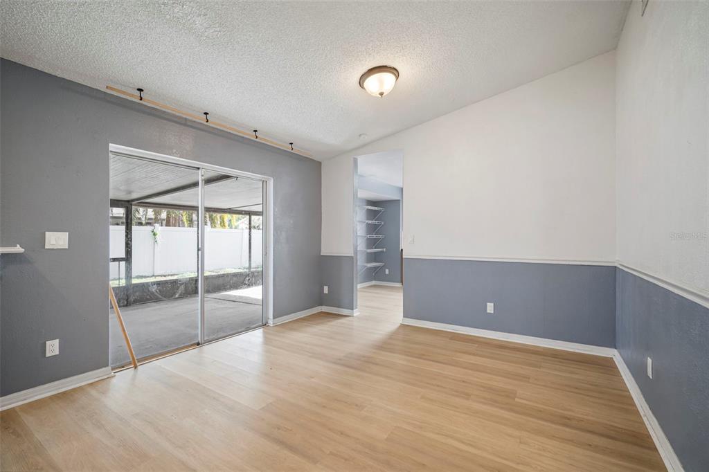 12825 Tallowood Drive Riverview, FL 33579 - Photo 20 of 43 an empty room with wooden floor and sliding door