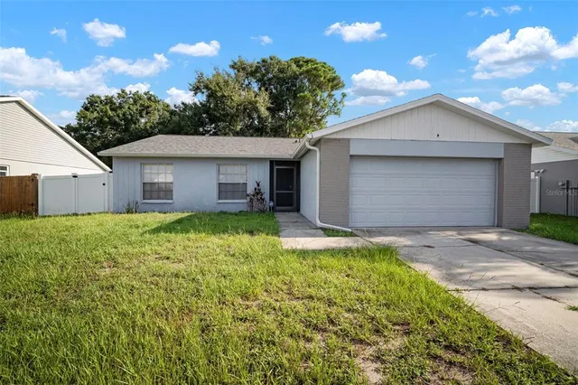 a view of a house with a yard and garage