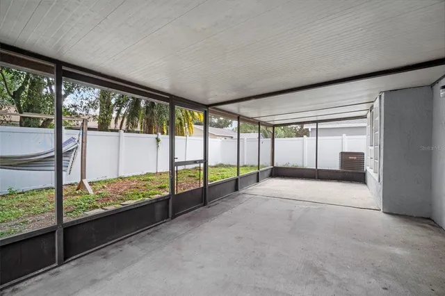 a view of empty room with floor to ceiling window