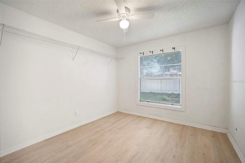 12825 Tallowood Drive Riverview, FL 33579 - Photo 10 of 43 an empty room with a window and a fan