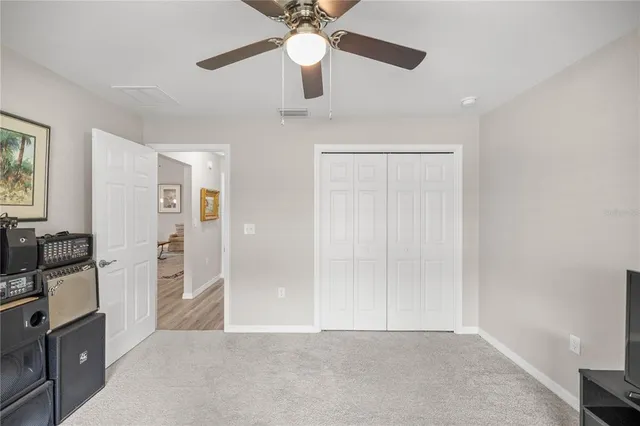 workspace with wooden floor closet and windows