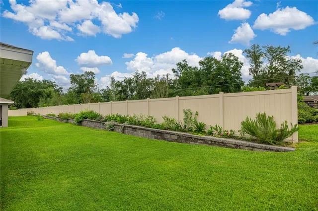 a view of yard with swimming pool and green space