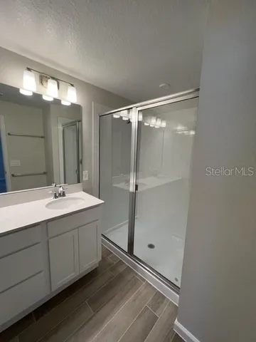 a bathroom with a double vanity sink and mirror