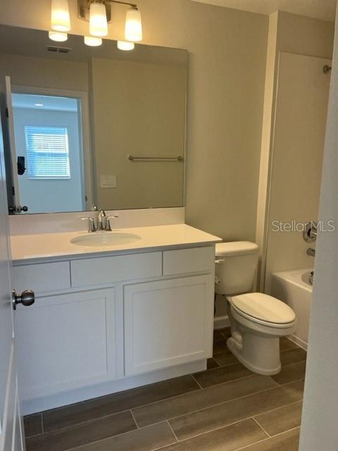 2327 Prickly Pear Way Sanford, FL 32771 - Photo 17 of 33 a bathroom with a sink a toilet and mirror