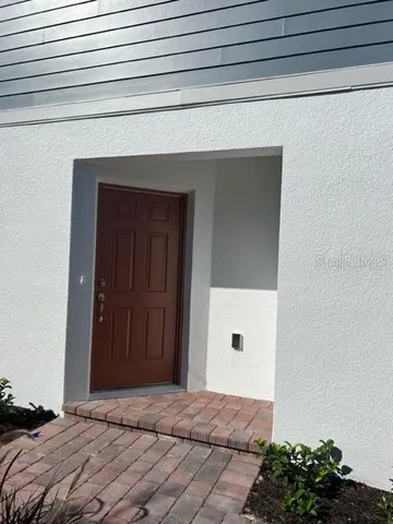 a bedroom with a bed and a potted plant