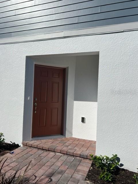 2327 Prickly Pear Way Sanford, FL 32771 - Photo 2 of 33 a bedroom with a bed and a potted plant