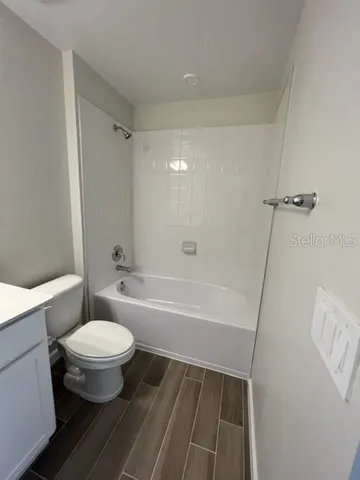 a bathroom with a toilet a sink and bathtub