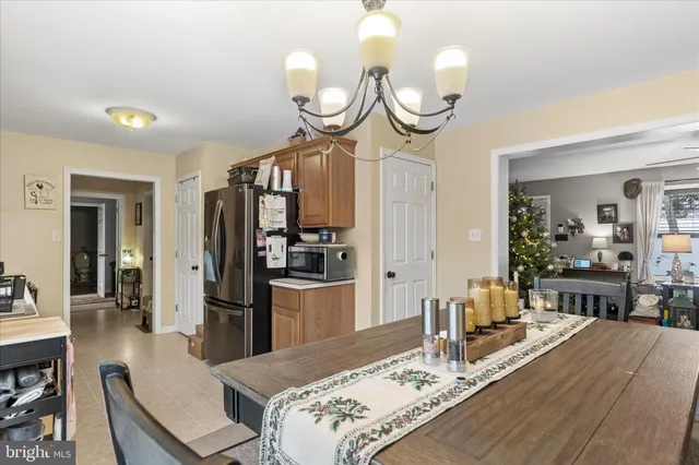 a view of a dining room and kitchen with wooden floor
