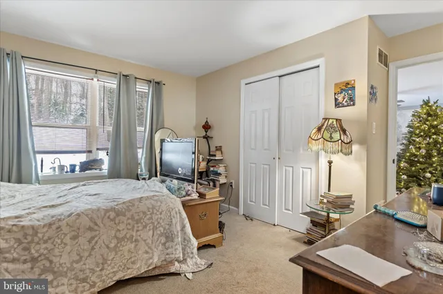 a bed room with a bed mirror and a window