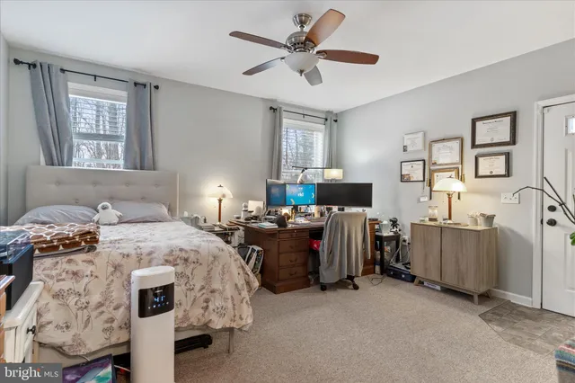 a bedroom with bed and a window