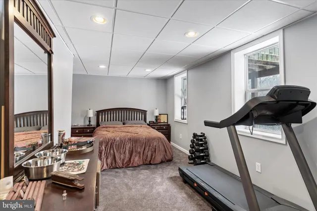 a bedroom with a bed and a mirror