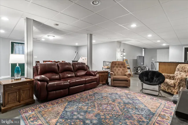 a living room with furniture and a rug