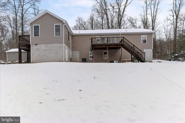 a view of a house with a snow in the yard