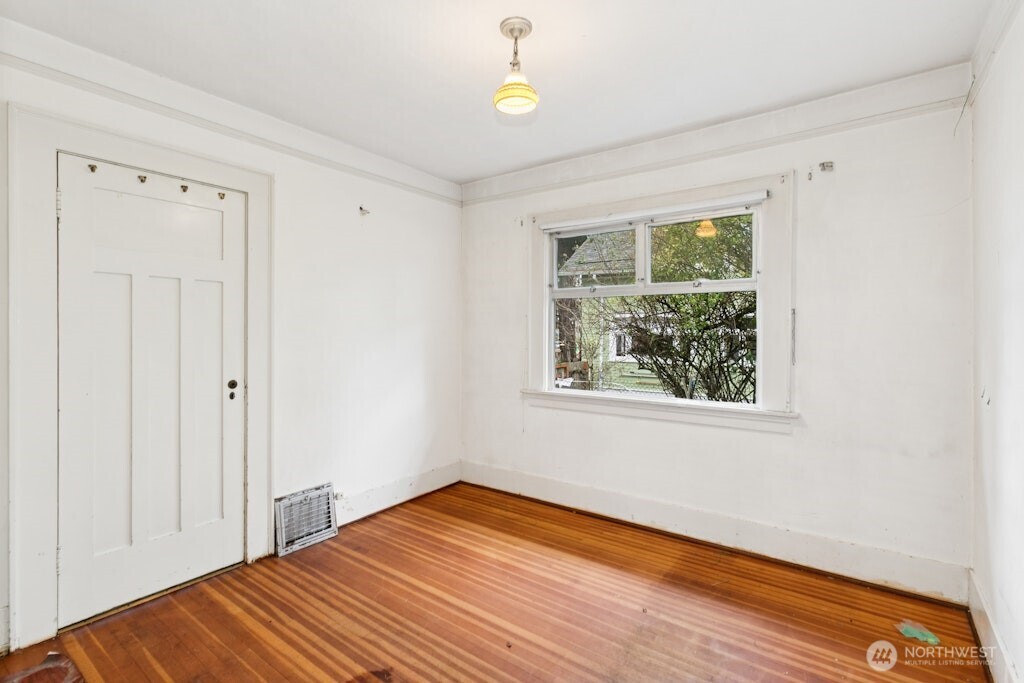 5627 44th Avenue Southwest Seattle, WA 98136 - Photo 16 of 37 a bedroom with a bed and a window
