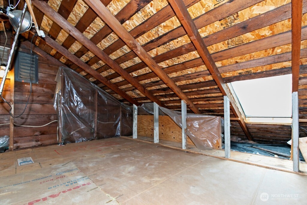 5627 44th Avenue Southwest Seattle, WA 98136 - Photo 19 of 37 a view of an empty room with wooden ceiling
