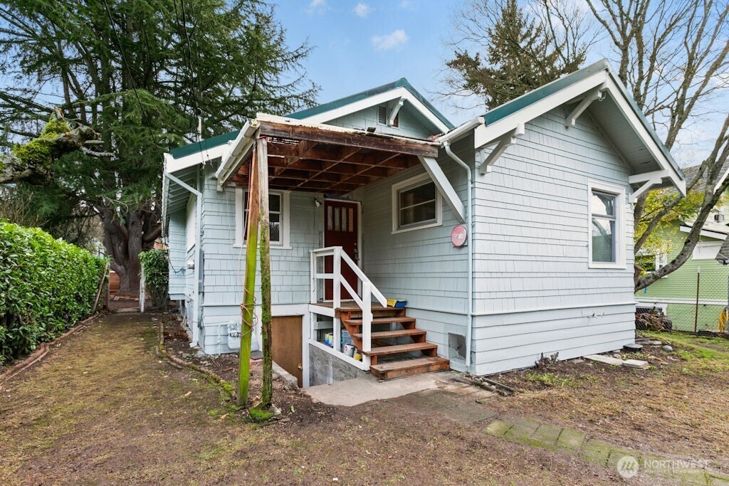 5627 44th Avenue Southwest Seattle, WA 98136 - Photo 21 of 37 a view of a house with a yard