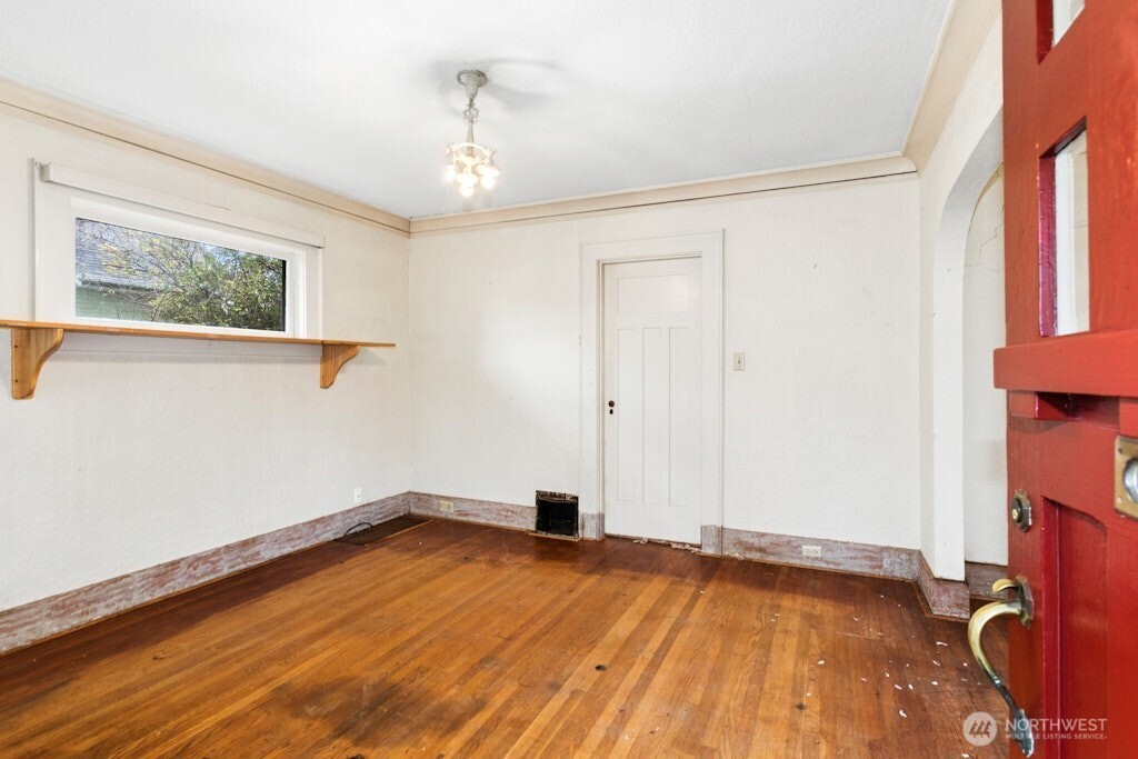 5627 44th Avenue Southwest Seattle, WA 98136 - Photo 5 of 37 a view of empty room with wooden floor and fan