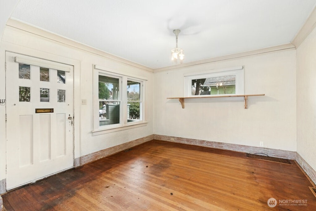 5627 44th Avenue Southwest Seattle, WA 98136 - Photo 6 of 37 a view of empty room with wooden floor and fan
