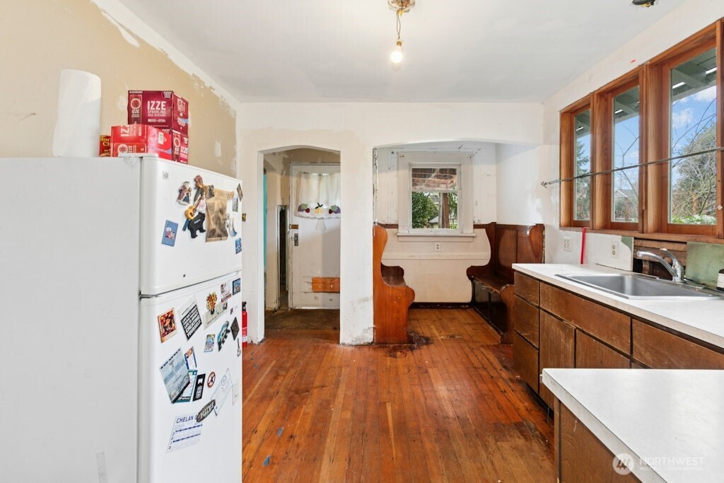 5627 44th Avenue Southwest Seattle, WA 98136 - Photo 10 of 37 a large white kitchen with a large window