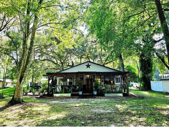 a front view of a house with a yard table and chairs
