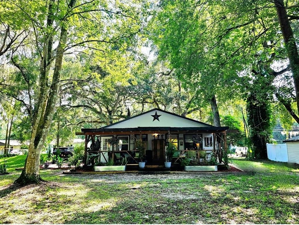 a front view of a house with a yard table and chairs