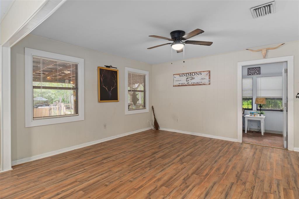353 North Robin Hood Road Inverness, FL 34450 - Photo 12 of 59 a view of empty room with wooden floor and fan