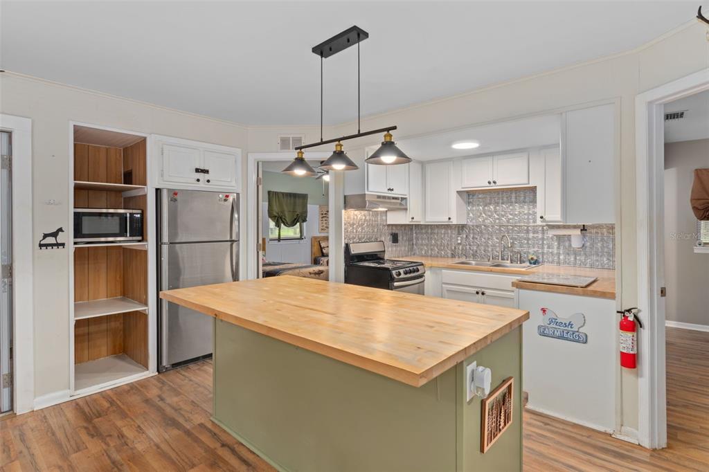 353 North Robin Hood Road Inverness, FL 34450 - Photo 14 of 59 a kitchen that has a lot of cabinets a sink and a stove in it