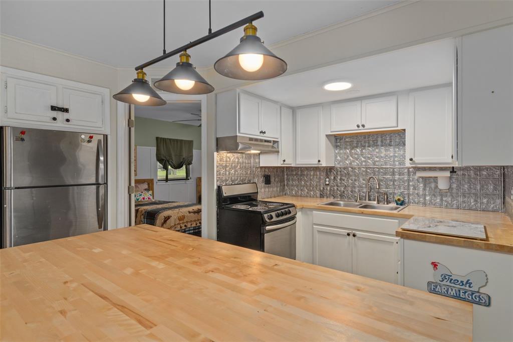 353 North Robin Hood Road Inverness, FL 34450 - Photo 16 of 59 a kitchen with a refrigerator a sink dishwasher with a stove and cabinets