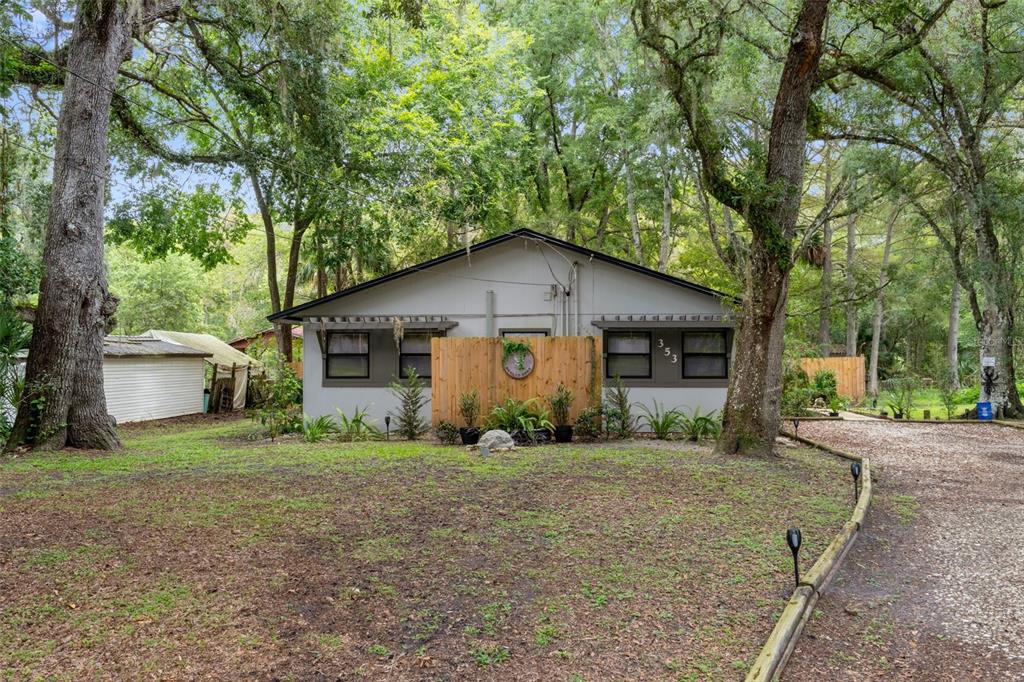 353 North Robin Hood Road Inverness, FL 34450 - Photo 2 of 59 a view of a house with a yard and large trees