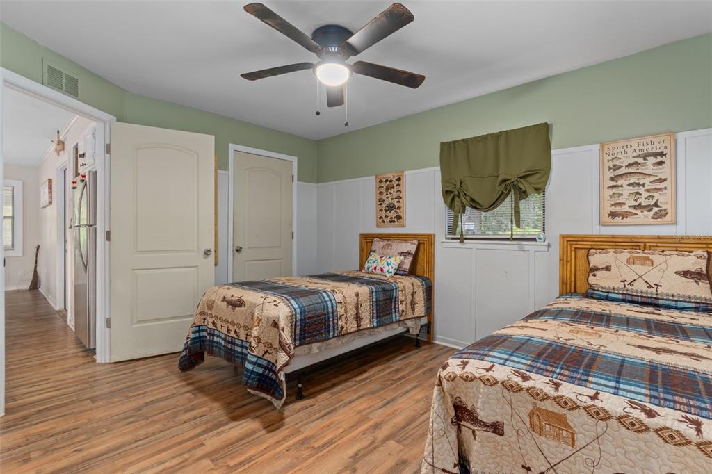 353 North Robin Hood Road Inverness, FL 34450 - Photo 27 of 59 a bedroom with a bed and a chandelier