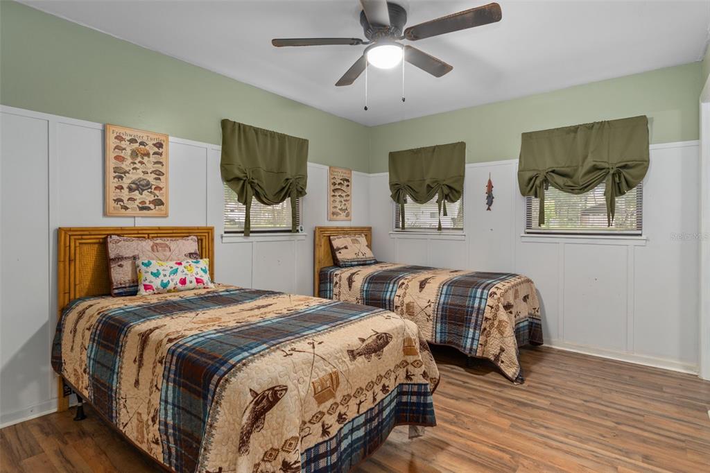 353 North Robin Hood Road Inverness, FL 34450 - Photo 28 of 59 a bedroom with two beds and painting on the wall