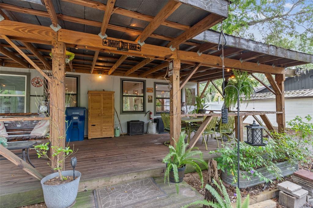 353 North Robin Hood Road Inverness, FL 34450 - Photo 36 of 59 a view of a patio with table and chairs potted plants
