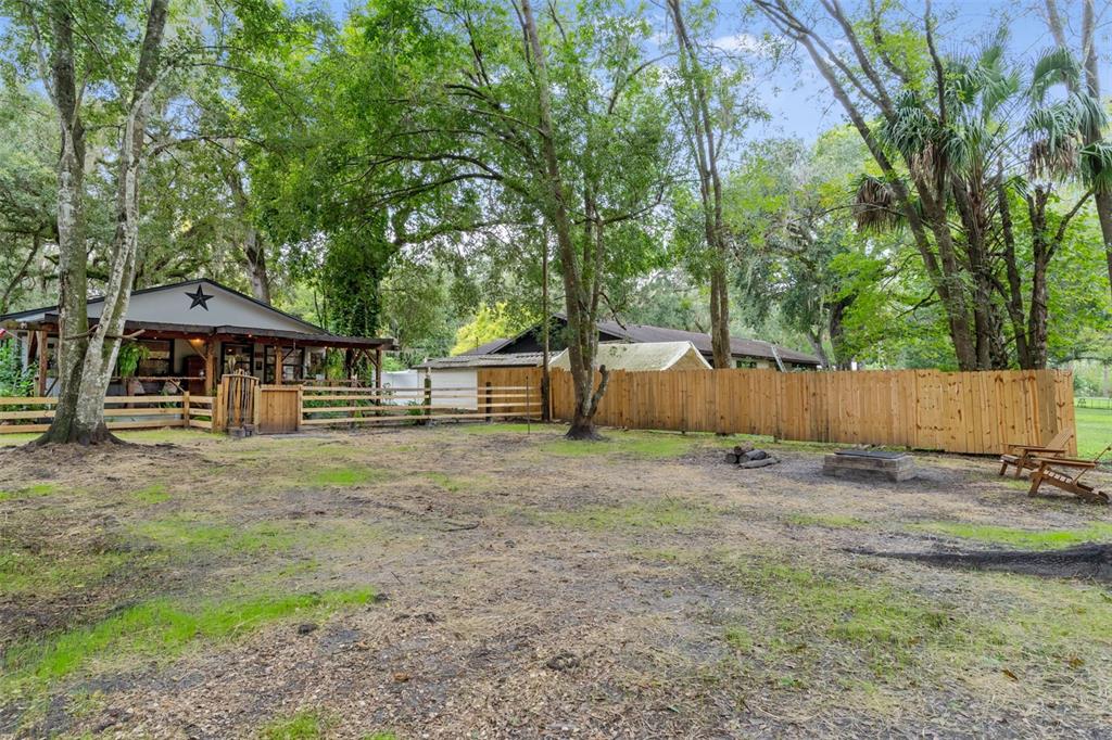 353 North Robin Hood Road Inverness, FL 34450 - Photo 41 of 59 a backyard of a house with trampoline and trees