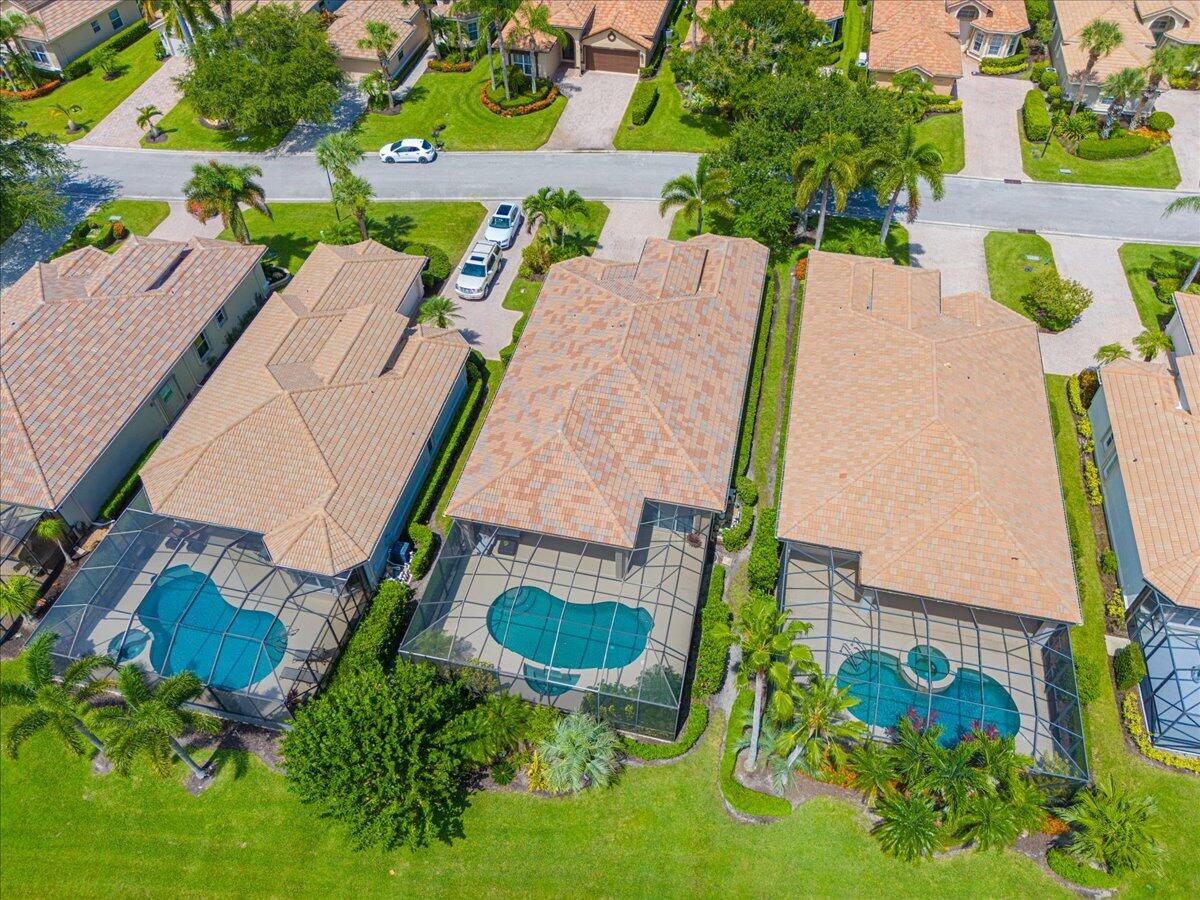 8332 Muirfield Way Port St. Lucie, FL 34986 - Photo 13 of 55 an aerial view of a house with swimming pool and garden