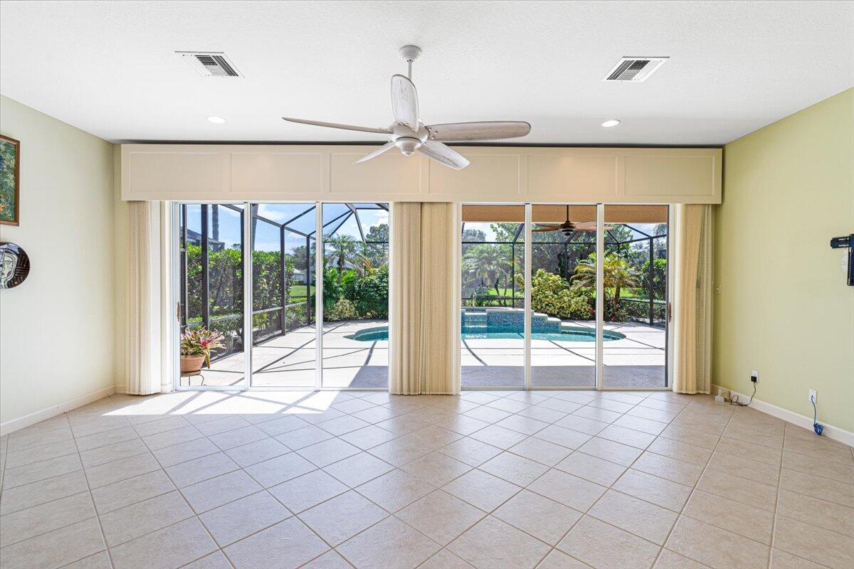 8332 Muirfield Way Port St. Lucie, FL 34986 - Photo 22 of 55 a view of empty room with floor to ceiling window and ceiling fan