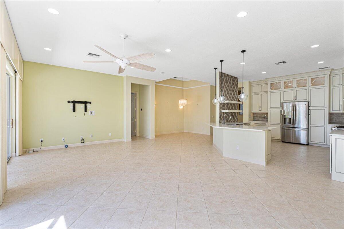 8332 Muirfield Way Port St. Lucie, FL 34986 - Photo 23 of 55 a view of a kitchen with refrigerator and chairs