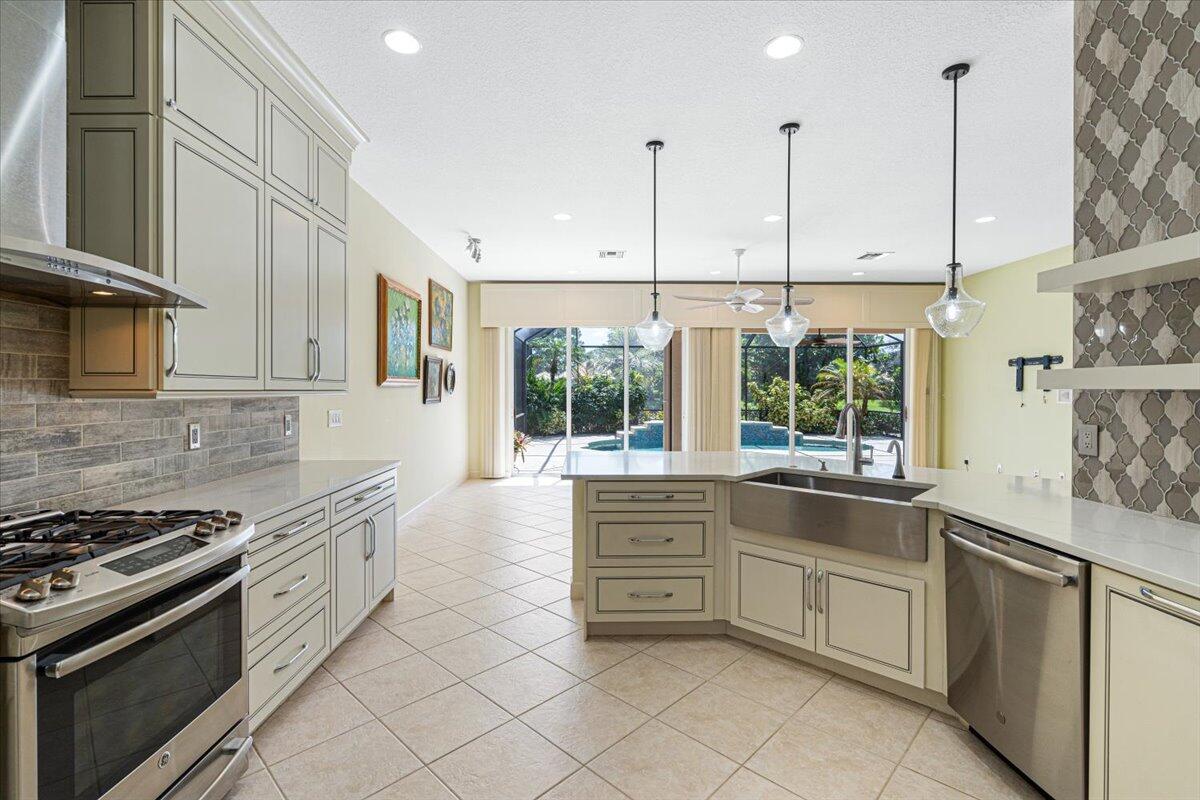 8332 Muirfield Way Port St. Lucie, FL 34986 - Photo 27 of 55 a kitchen with stainless steel appliances granite countertop a stove and a sink