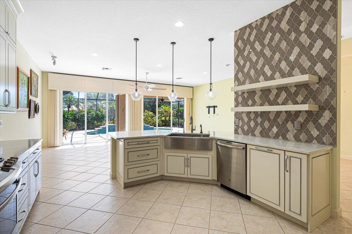 8332 Muirfield Way Port St. Lucie, FL 34986 - Photo 28 of 55 a kitchen with stainless steel appliances granite countertop a stove and a sink