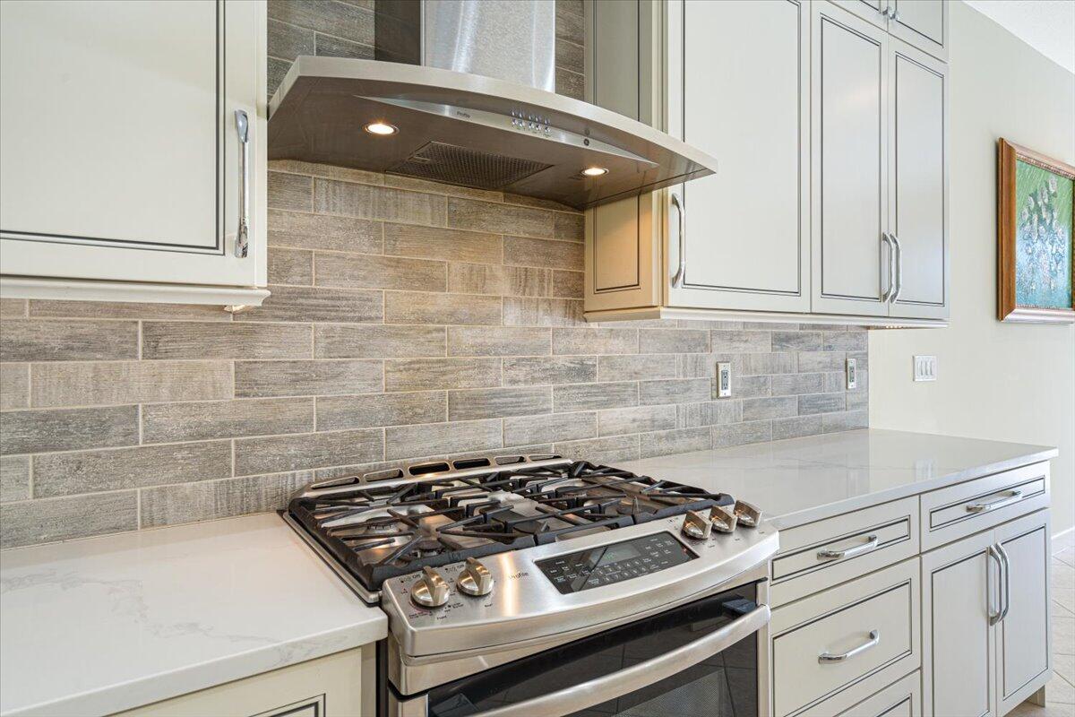 8332 Muirfield Way Port St. Lucie, FL 34986 - Photo 31 of 55 a stove top oven sitting inside of a kitchen