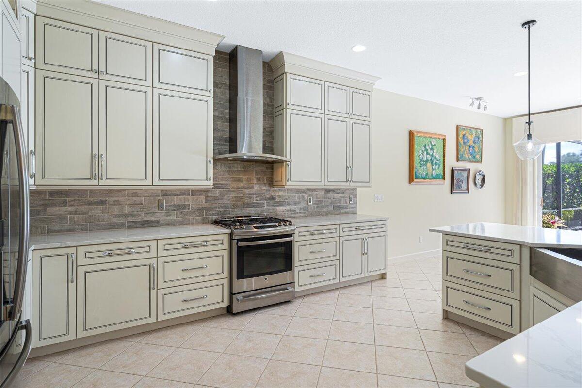 8332 Muirfield Way Port St. Lucie, FL 34986 - Photo 33 of 55 a kitchen with stainless steel appliances granite countertop a stove and a sink