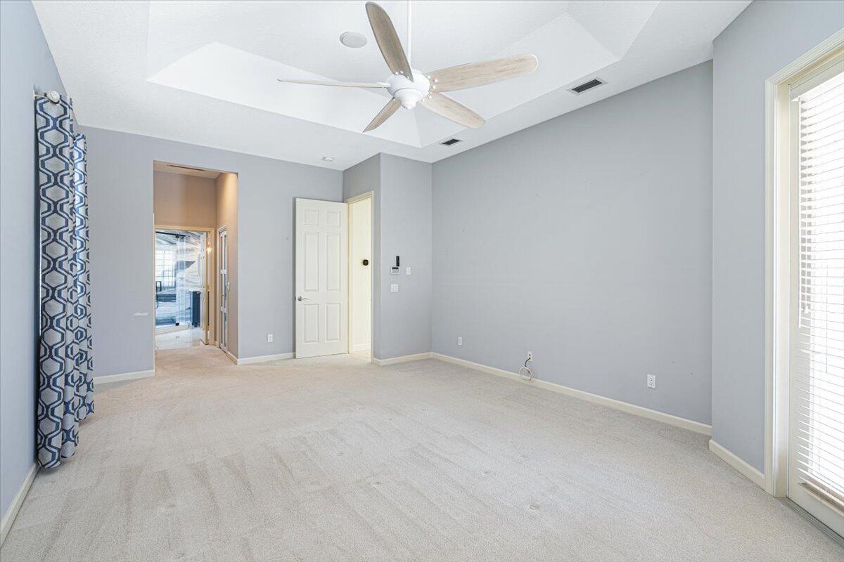 8332 Muirfield Way Port St. Lucie, FL 34986 - Photo 36 of 55 an empty room with windows and a ceiling fan